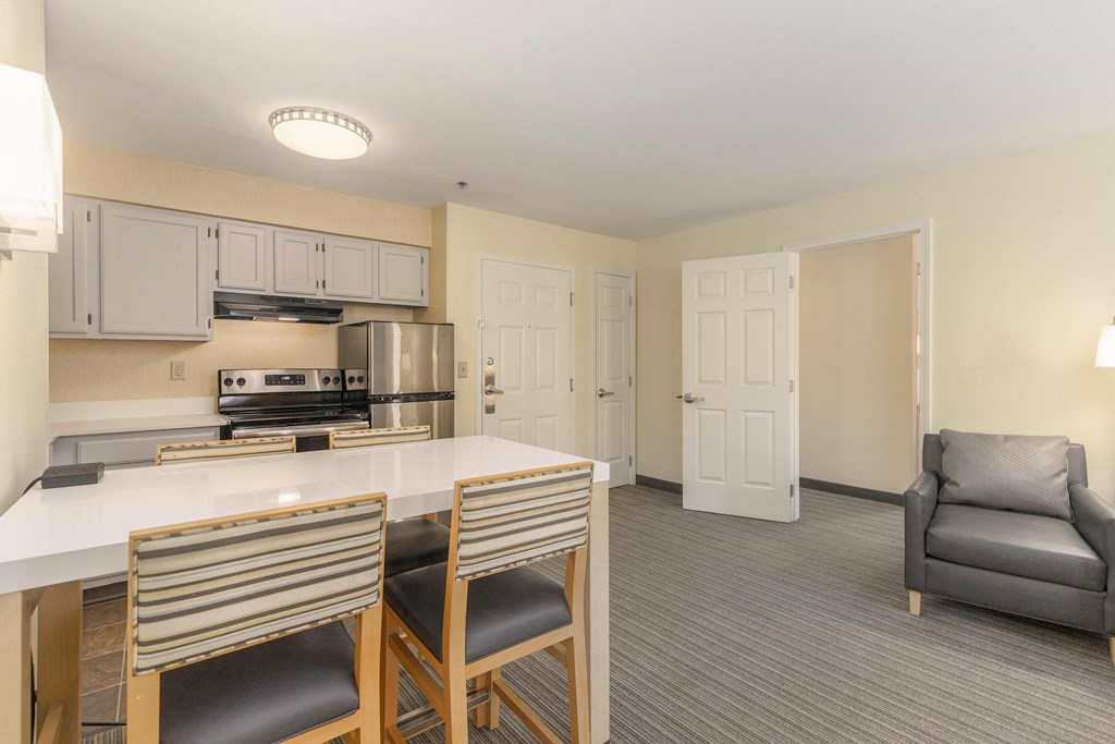 a kitchen and living room with a table and chairs